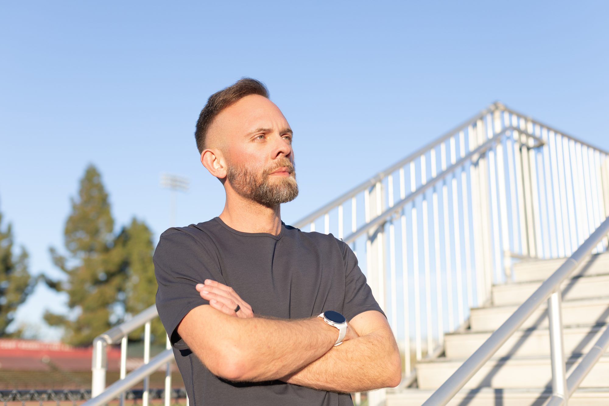 Bart with arms crossed against a blue sky